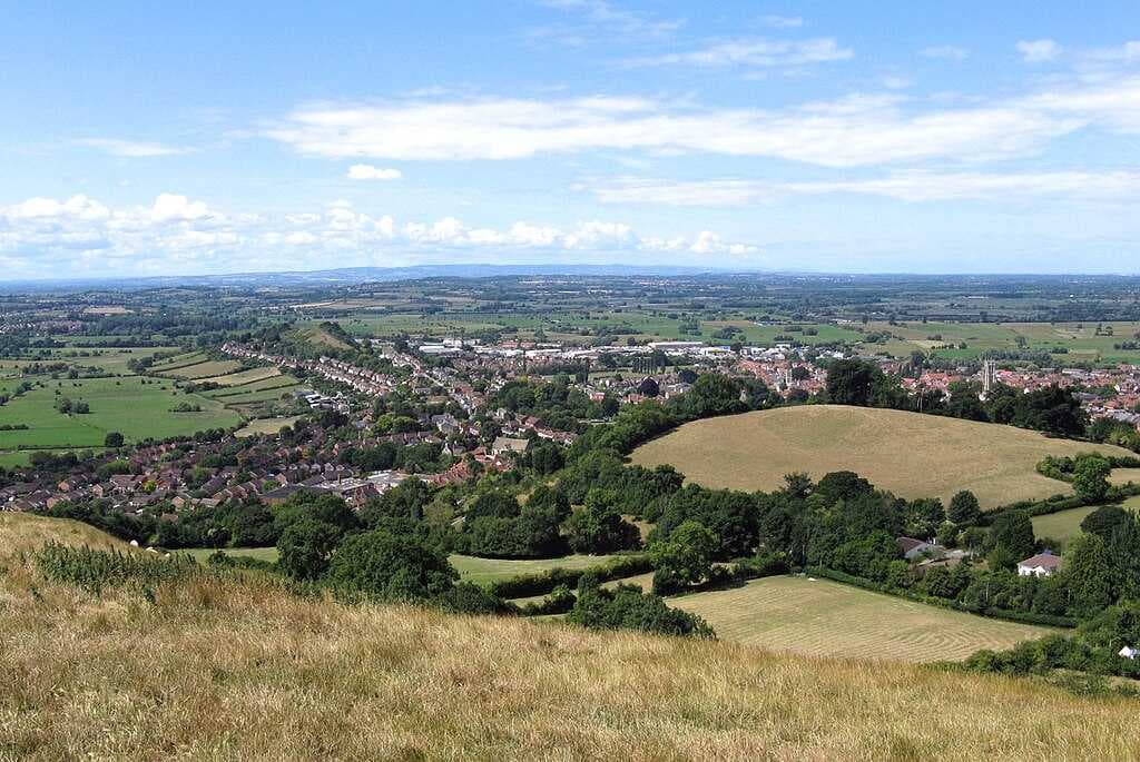 The town of Glastonbury looking west from the top of Glastonbury Tor. The fields in the distance are the Somerset Levels.