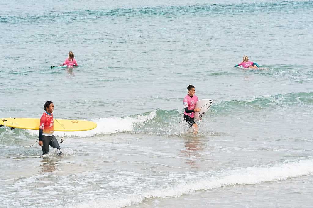 Surfers participate in a demonstration for the 2019 G7 Summit