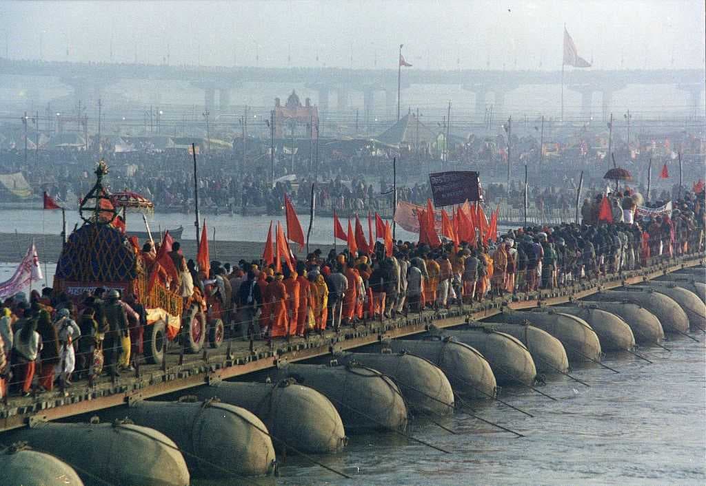 A procession of pilgrims cross the Ganga during the 2001 Kumbh Mela in Allahabad