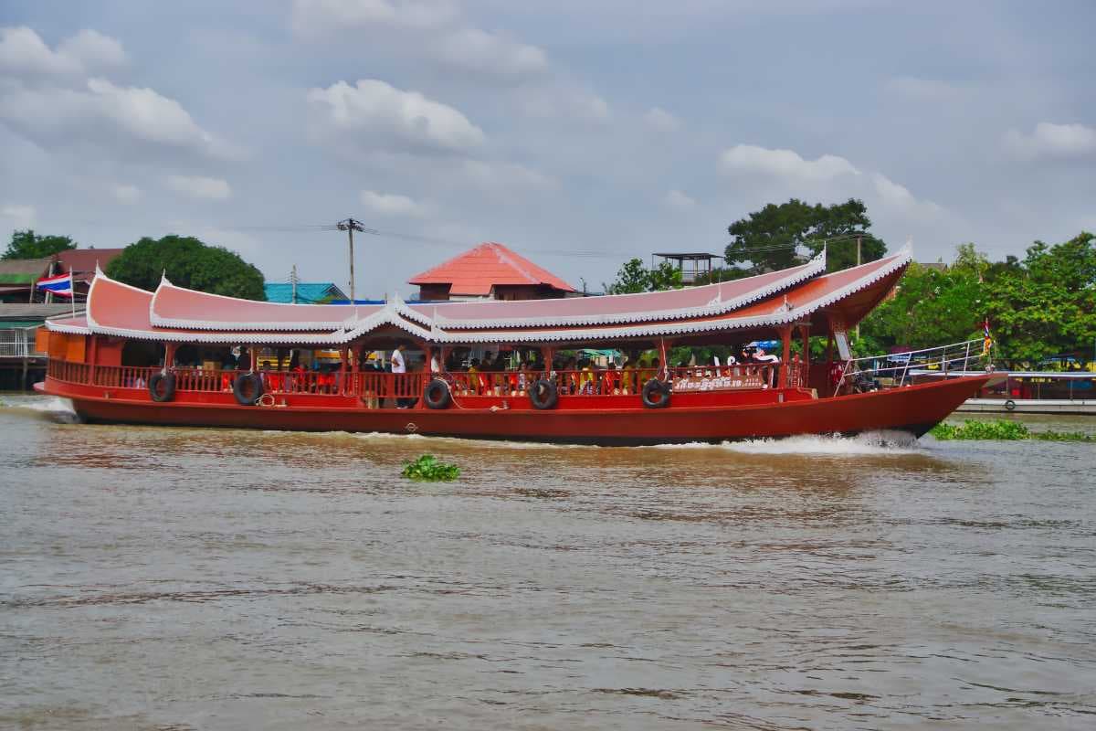 Tour boat passing Koh Kret island on the Chao Phraya river