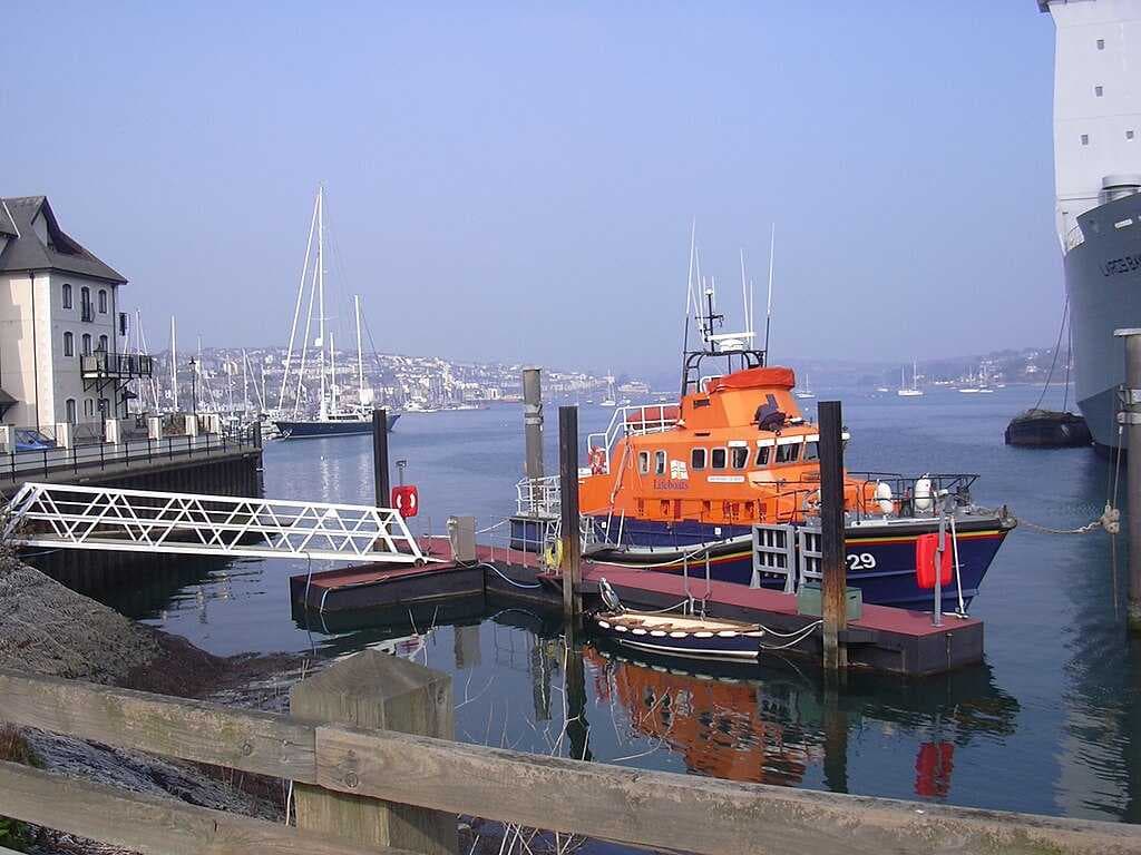 The Falmouth Lifeboat moored by the docks with the old town and The Penryn River in the background