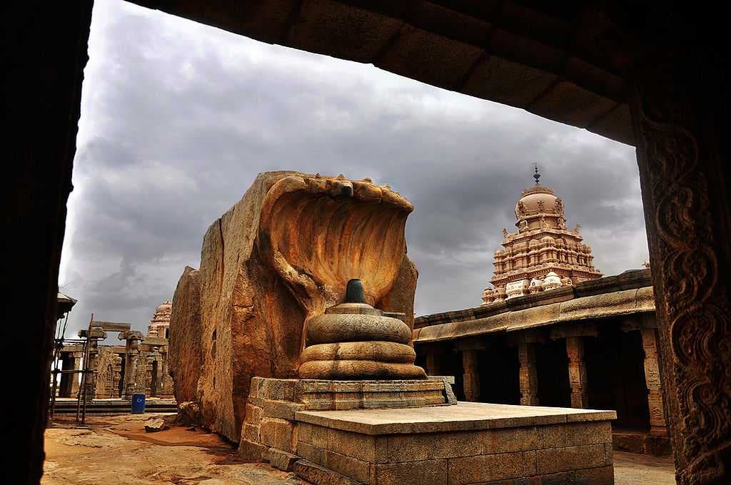 The hooded serpent Naaga shading the lingam sculpture