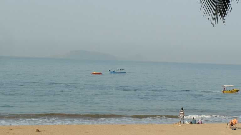 Boats at a distance from the beach.