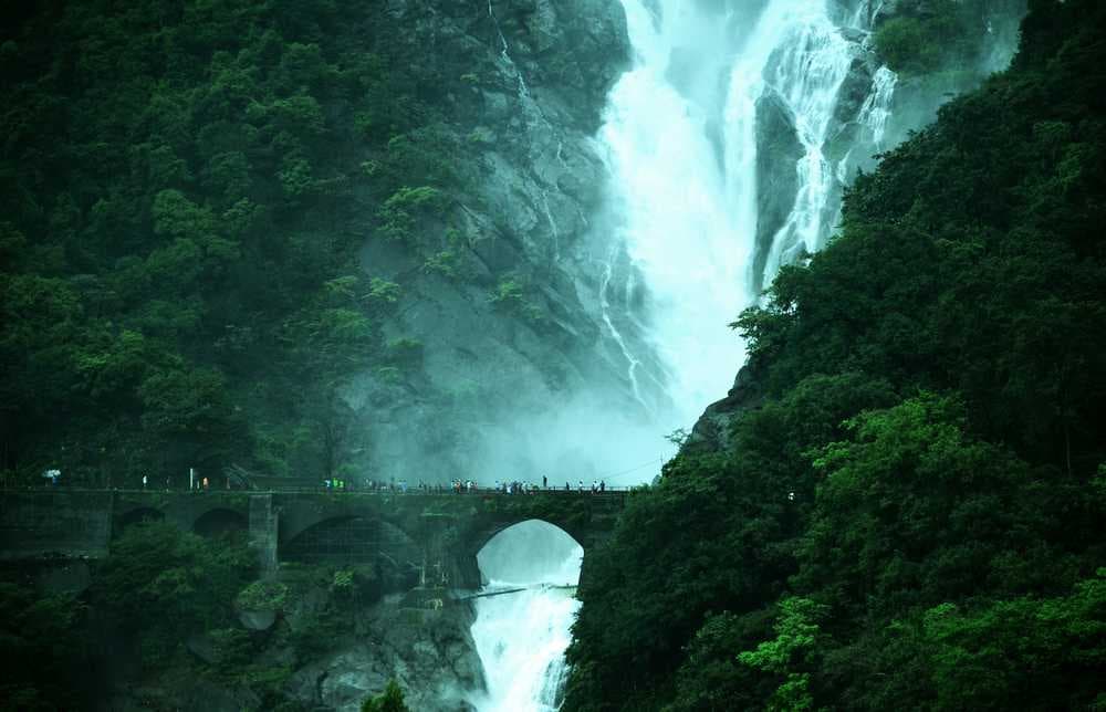 Misty Morning View of Dudhsagar Falls with Railway Bridge