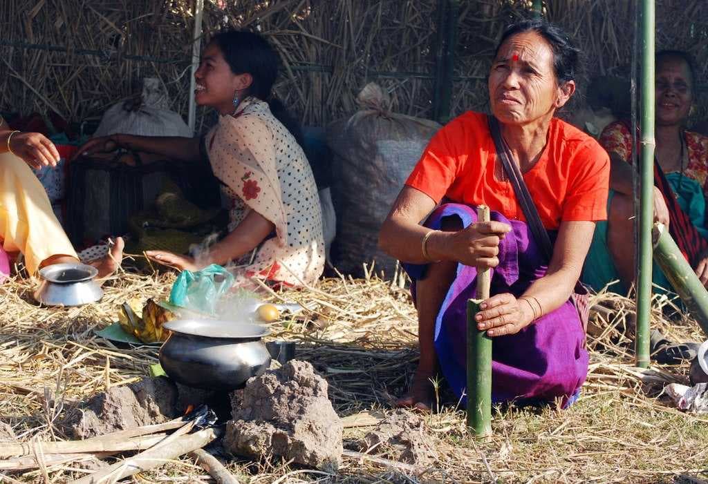 A Tiwa woman preparing food at the mela