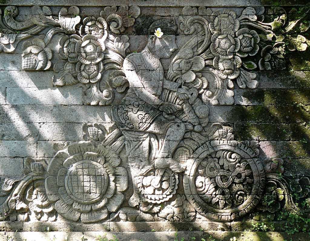 A bas-relief on the side of the main shrine in Pura Meduwe Karang is believed to be the depiction of Dutch artist W.O.J. Nieuwenkamp who explored Bali by bike in 1904.