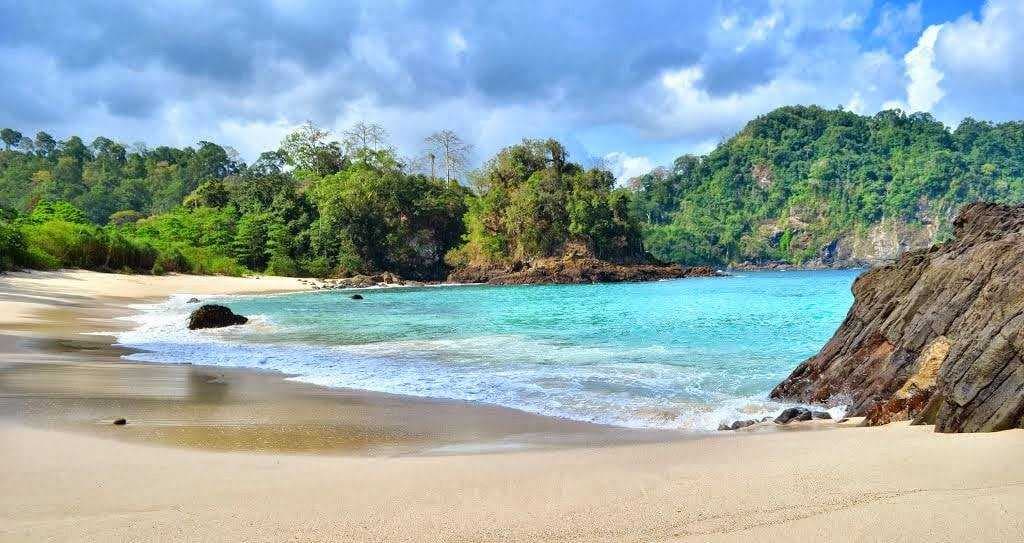 Tourists enjoying the beautiful sunset at Sukamade Beach in Banyuwangi, Indonesia