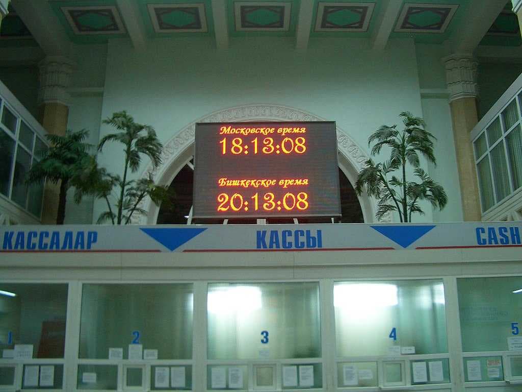 The electronic board in the main hall of Bishkek-2, the main train station, shows Bishkek and Moscow time.