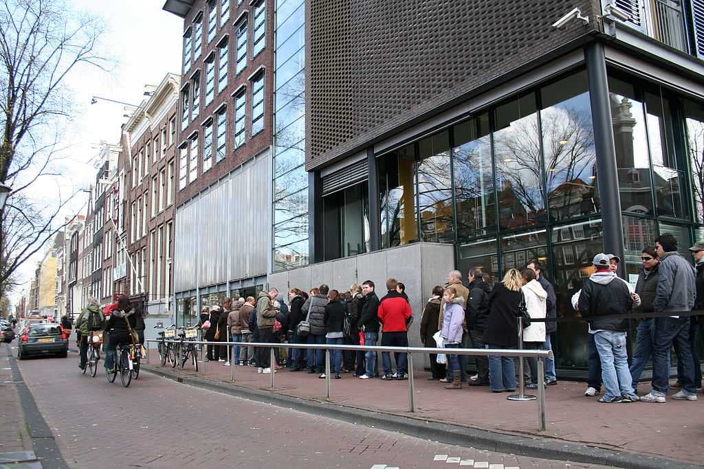 Visitors queueing in front of the museum entrance.
