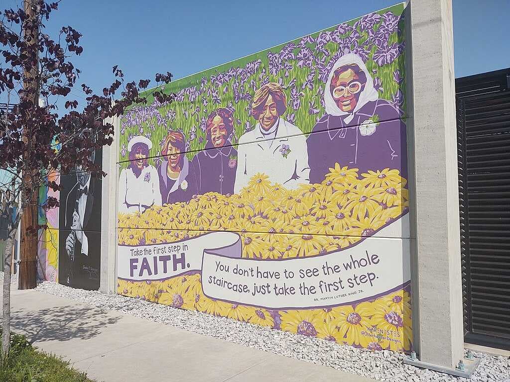 A downtown mural memorializing the five Black women who were injured during the 1980 Klan shooting.
