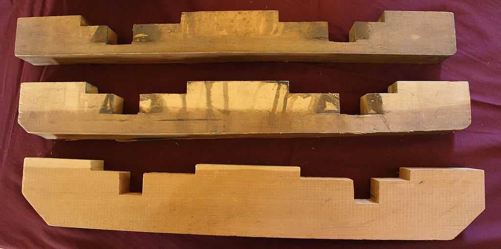 Cable car brake blocks in three different states of usage, from new (bottom) to near end of life (top)