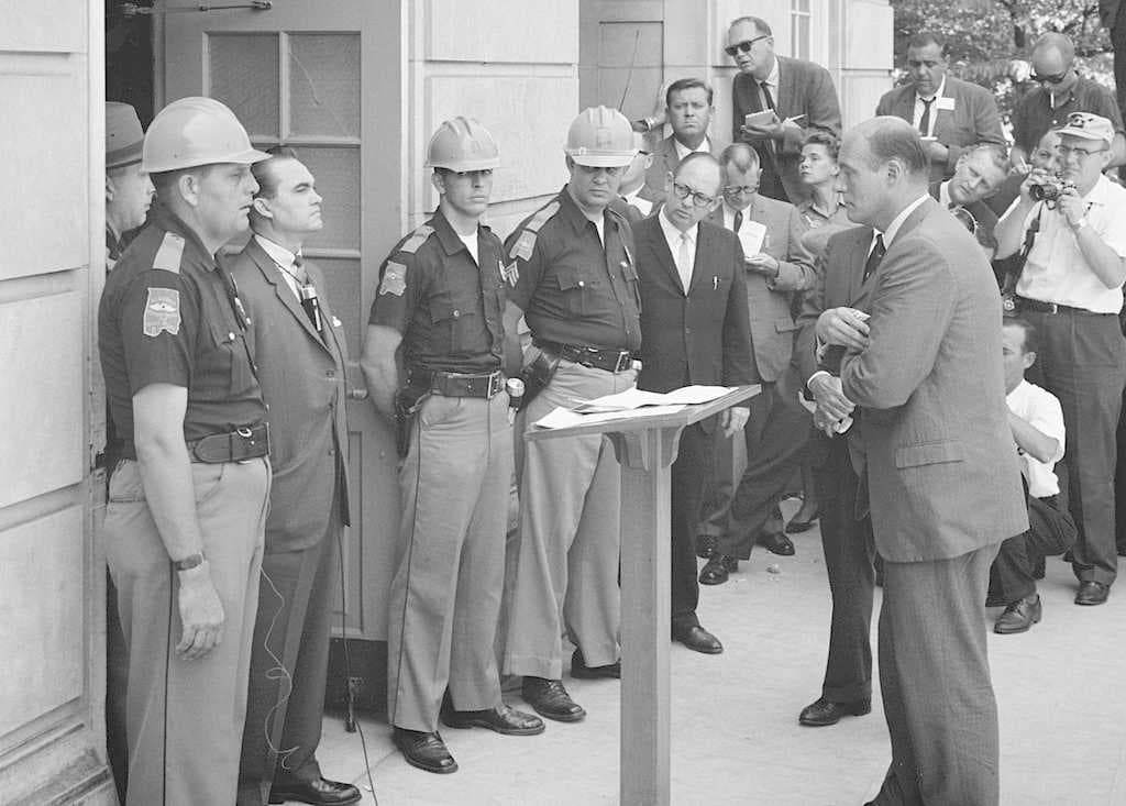Wallace standing against desegregation while being confronted by Deputy U.S. Attorney General Nicholas Katzenbach at the University of Alabama in 1963