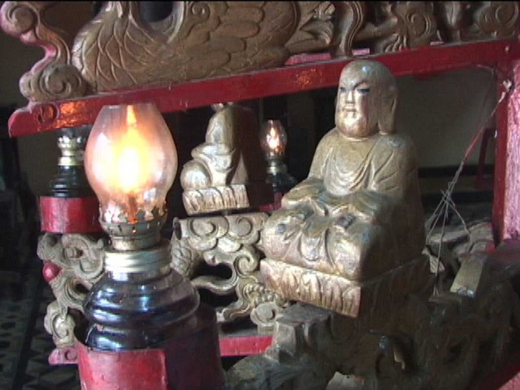 This little contemplative figure is part of a large candle-holder, in which each candle is faced by such a figure.